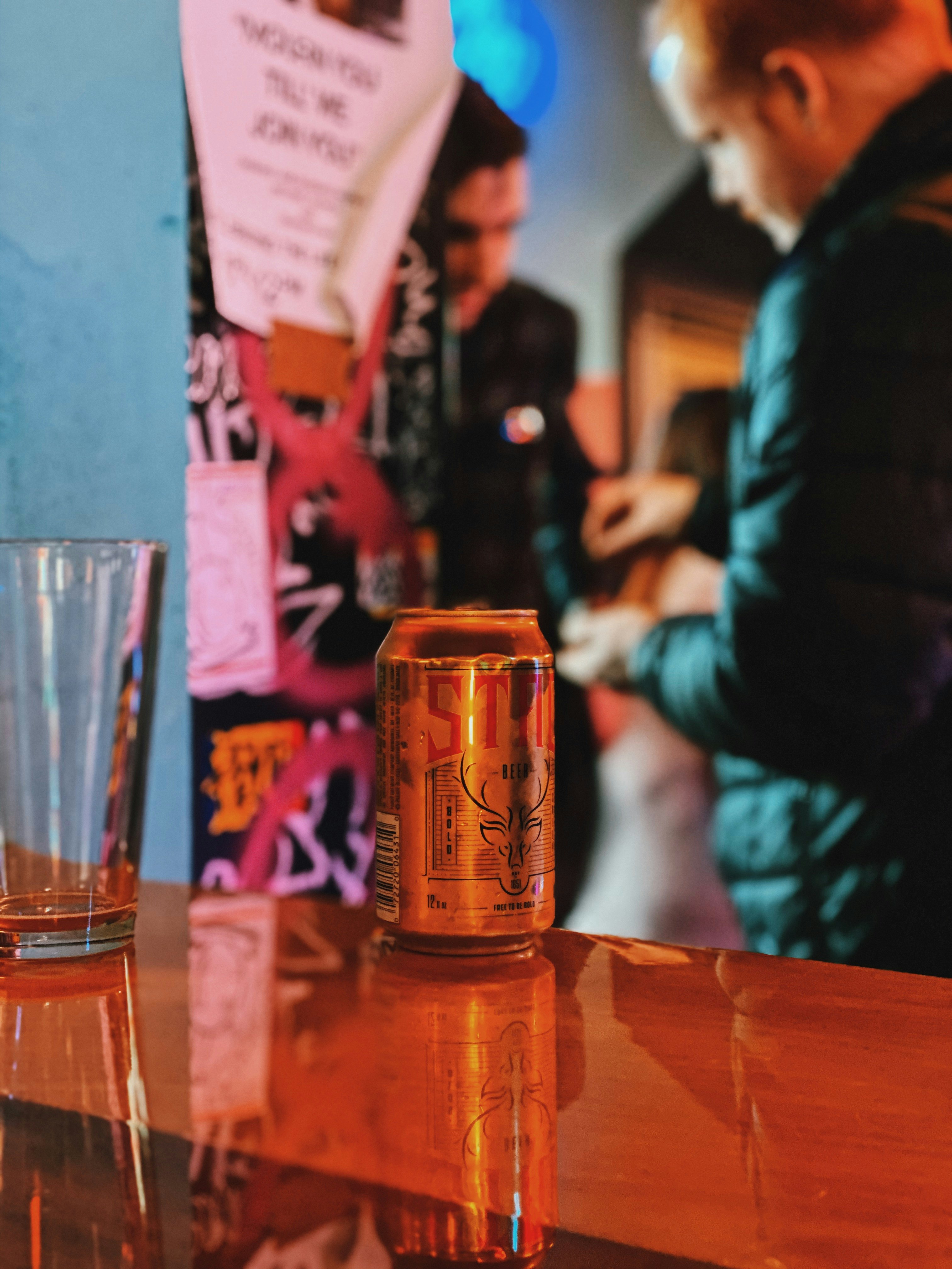 red and yellow can on brown wooden table